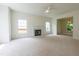 Spacious living room with fireplace, ceiling fan, and abundant natural light from the windows at 2441 Deanwood Dr, Raleigh, NC 27615