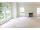 Bright living room features a fireplace and multiple large windows for natural light and outdoor views at 2441 Deanwood Dr, Raleigh, NC 27615