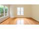 Bright living room with hardwood floors and large windows offering beautiful views at 2441 Deanwood Dr, Raleigh, NC 27615