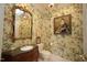 Charming powder room featuring floral wallpaper, elegant fixtures, and decorative mirror adding a touch of character at 2901 Market Bridge Ln # 203, Raleigh, NC 27608