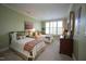 Inviting bedroom featuring two twin beds, soft green walls, and bright natural light at 2901 Market Bridge Ln # 203, Raleigh, NC 27608