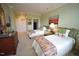 Inviting bedroom featuring two twin beds, soft green walls, and bright natural light at 2901 Market Bridge Ln # 203, Raleigh, NC 27608