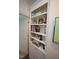 White built-in shelves beside a doorway with various books and decorative items on display at 2901 Market Bridge Ln # 203, Raleigh, NC 27608