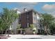 Exterior view of a stately multi-story building showcasing classic brick and stucco architecture and mature trees at 2901 Market Bridge Ln # 203, Raleigh, NC 27608