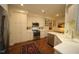 Well-appointed kitchen boasts stainless steel appliances, white cabinetry, and a cozy breakfast area with wood flooring at 2901 Market Bridge Ln # 203, Raleigh, NC 27608