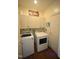 Functional laundry room equipped with modern washer and dryer, cabinetry, and ample space at 2901 Market Bridge Ln # 203, Raleigh, NC 27608