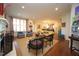 Open-concept living room with ample seating, hardwood floors, and view into dining area at 2901 Market Bridge Ln # 203, Raleigh, NC 27608