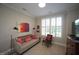 Bright room with daybed and accent chair by a window with white shutters at 2901 Market Bridge Ln # 203, Raleigh, NC 27608
