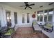 Cozy patio area with seating, stylish rug, ceiling fan, and natural light from windows and French doors at 2901 Market Bridge Ln # 203, Raleigh, NC 27608