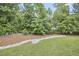 Manicured backyard featuring rock-lined stream bed and lush green lawn at 2916 Reynolda Cir, Durham, NC 27712