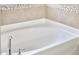 Close-up of a modern bathtub with stylish fixtures and tile accents at 2916 Reynolda Cir, Durham, NC 27712