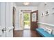 Open foyer with hardwood floors, decorative front door leading to landscaped yard at 2916 Reynolda Cir, Durham, NC 27712
