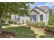 Charming home exterior featuring stone accents, neat landscaping, blue shutters and a well-manicured lawn at 2916 Reynolda Cir, Durham, NC 27712