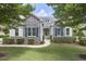 Charming stone-accented home with lush lawn, trimmed shrubbery, and blue shutters at 2916 Reynolda Cir, Durham, NC 27712