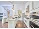 Spacious kitchen with stainless steel appliances, center island, and seamless flow into the dining area at 2916 Reynolda Cir, Durham, NC 27712