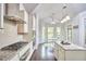 Well-lit kitchen featuring modern appliances, a center island, and a breakfast nook with bay windows at 2916 Reynolda Cir, Durham, NC 27712