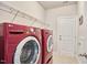 Bright laundry room features a modern red washer and dryer set with wire rack shelving at 2916 Reynolda Cir, Durham, NC 27712