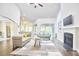 Open-concept living room with hardwood floors, fireplace, and seamless access to kitchen at 2916 Reynolda Cir, Durham, NC 27712