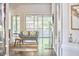 View of the screened-in porch from the living room with a hardwood floor and a soft blue sofa at 2916 Reynolda Cir, Durham, NC 27712