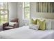 Comfortable main bedroom featuring natural light, hardwood floors, and a cozy reading chair at 2916 Reynolda Cir, Durham, NC 27712