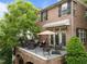 View of the spacious deck from a brick house overlooking the lush green yard at 2921 Imperial Oaks Dr, Raleigh, NC 27614