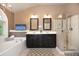 Bathroom features a soaking tub, walk-in shower, double sink vanity, and wall-mounted television at 2921 Imperial Oaks Dr, Raleigh, NC 27614