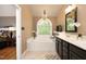 Bathroom featuring a soaking tub under a window, a chandelier, and a double sink vanity at 2921 Imperial Oaks Dr, Raleigh, NC 27614