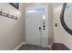Bright foyer featuring a white front door with sidelight and transom, complemented by neutral walls and a coat rack at 2921 Imperial Oaks Dr, Raleigh, NC 27614
