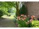 Landscaped side yard features flower beds, trees, and grass at 2921 Imperial Oaks Dr, Raleigh, NC 27614