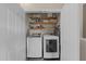 Laundry room offers a washer, a dryer and storage shelves within a closet at 2921 Imperial Oaks Dr, Raleigh, NC 27614