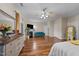 Spacious main bedroom with hardwood floors, ceiling fan, fireplace, and multiple closets and entry doors at 2921 Imperial Oaks Dr, Raleigh, NC 27614