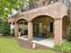 Rear view of covered patio with outdoor seating, a brick ceiling with brick arches, and a garden view at 2921 Imperial Oaks Dr, Raleigh, NC 27614
