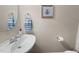Charming powder room features a modern sink, decorative bee artwork, and fresh towel at 2921 Imperial Oaks Dr, Raleigh, NC 27614