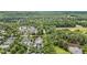 A wide aerial view of the community with lush greenery and a tranquil pond at 3 Yancey, Pittsboro, NC 27312