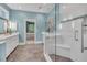 Bright bathroom features a glass shower, double vanity, and blue accent wall at 3 Yancey, Pittsboro, NC 27312