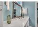 Close up view of a double vanity with a large mirror and modern lighting at 3 Yancey, Pittsboro, NC 27312