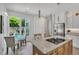 Bright kitchen with stainless appliances, cooktop island with granite countertops, and adjacent dining area near backyard view at 3 Yancey, Pittsboro, NC 27312