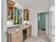 Kitchenette area featuring a wine cooler, granite counters, and natural wood cabinetry at 3 Yancey, Pittsboro, NC 27312