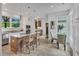 Kitchen and eat-in area with tile flooring, granite countertops, stainless steel appliances, an island, and barstool seating at 3 Yancey, Pittsboro, NC 27312
