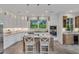 Bright kitchen featuring white cabinets, granite countertops, stainless steel appliances, an island, and barstool seating at 3 Yancey, Pittsboro, NC 27312