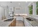 Modern kitchen featuring white cabinets, granite countertops, stainless steel appliances, and an island with cooktop at 3 Yancey, Pittsboro, NC 27312