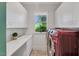 Laundry room features a sink, white cabinetry, and front-loading washer and dryer at 3 Yancey, Pittsboro, NC 27312