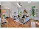 Bright living room with hardwood floors, fireplace, and large windows with white shutters at 3 Yancey, Pittsboro, NC 27312