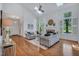 Open floor plan features living room with vaulted ceilings, fireplace, hardwood floors, sofas, rug, and large windows at 3 Yancey, Pittsboro, NC 27312