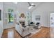Open living room with a fireplace, natural light, and two sofas at 3 Yancey, Pittsboro, NC 27312