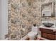 Charming powder room with unique floral wallpaper, vessel sink, and wood vanity at 3 Yancey, Pittsboro, NC 27312