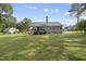 Backyard featuring mature trees and a view of the house from the backyard at 30 Cornerstone Dr, Franklinton, NC 27525