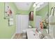 Bathroom featuring a single vanity and a shower tub combination with light green walls at 30 Cornerstone Dr, Franklinton, NC 27525