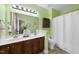 Bathroom features a double vanity and a shower tub combination with light green paint at 30 Cornerstone Dr, Franklinton, NC 27525