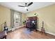Bedroom with laminated floors, a ceiling fan, a window, and musical instruments at 30 Cornerstone Dr, Franklinton, NC 27525